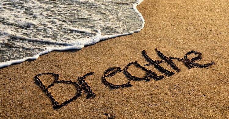 Picture of beach with Breathe written in sand